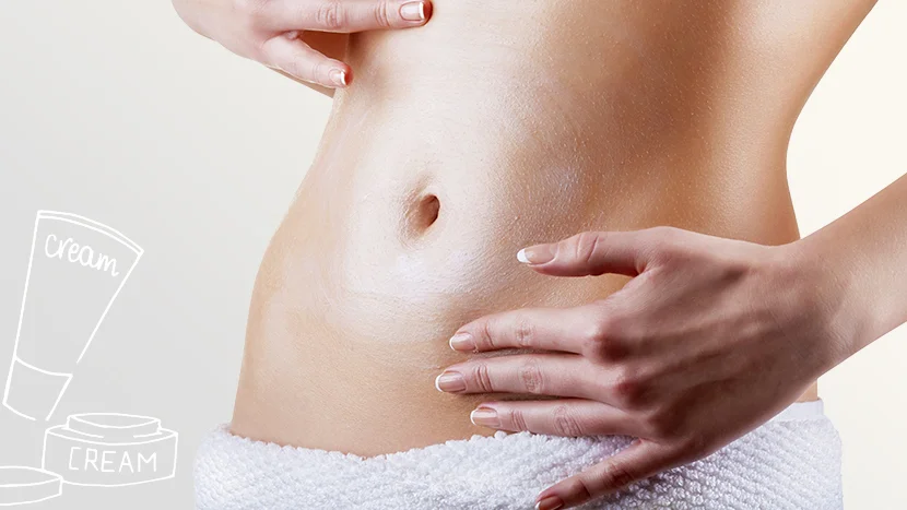 a close-up of a woman applying creme to her stomach